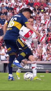 a soccer player with the number 16 on his jersey kicks the ball