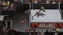 two wrestlers are fighting in a ring with a banner that says hell in a cell