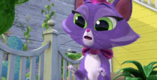 a purple cat with green eyes is standing in front of a yellow house .