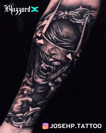 a black and white tattoo of a laughing batman on a person 's arm