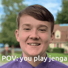 a young man in a purple shirt is smiling with the words pov you play jenga below him