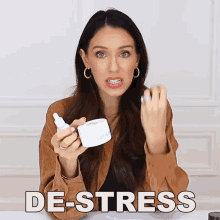 a woman is holding a jar of lotion and a bottle of serum and the word de-stress is on the bottom