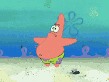 patrick star from spongebob squarepants is standing in the sand
