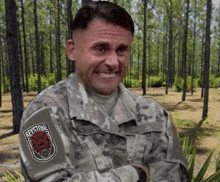 a man in a military uniform has a keystone patch on his chest