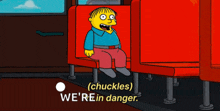 a cartoon character is sitting in a red chair with the words " we 're in danger " above him