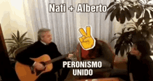 a man playing a guitar with the words nati + alberto peronismo unido