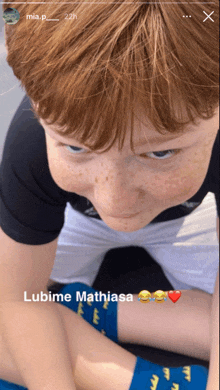 a close up of a child 's face with the words " lubime mathiasa " below it