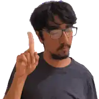 a man wearing glasses and a black shirt points his finger up