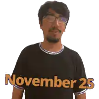 a man wearing a black shirt that says november 25 on it