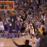 a basketball game is being played in front of a crowd with a sign that says yof on it