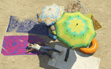 a person laying on a beach with umbrellas and a towel