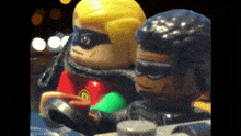 a close up of two lego figures wearing masks