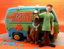 a cake with scooby doo and a mystery machine van on it