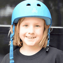 a young boy wearing a blue helmet with the number 8 on the front