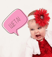 a baby with a red flower in her hair and a pink speech bubble that says ' cheta ' on it