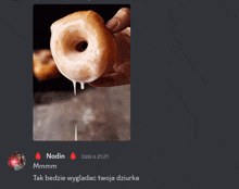 a picture of a person holding a donut with icing dripping from it