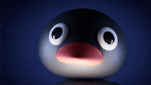 a penguin with big eyes and a red beak looks at the camera