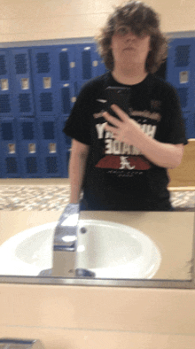 a person taking a picture of themselves in a bathroom mirror