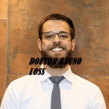 a man with glasses and a beard is wearing a white shirt and tie with the name doutor bruno loss above him