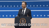 elon musk is giving a speech at a podium in front of a microphone .