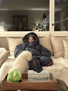 a person is laying on a couch with a bag of oatmeal on a tray