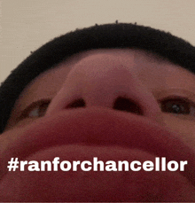 a close up of a person 's nose with the words #ranforchancellor written on it