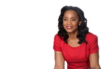 a woman in a red dress is smiling and looking away from the camera