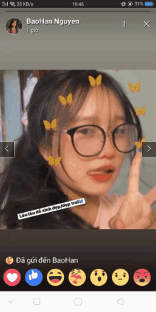 a phone screen shows a girl wearing glasses and butterflies