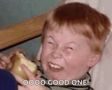 a young boy is making a funny face while holding a piece of cheese and saying `` good one '' .