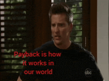 a man standing in front of a window with payback is how it works in our world