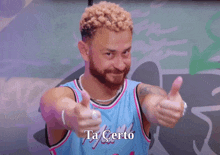 a man in a miami jersey giving two thumbs up with ta certo written below him