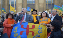 a group of people are holding a flag with a x on it