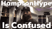 a baseball player with a beard is standing in a locker room with the words hampton hype is confused .