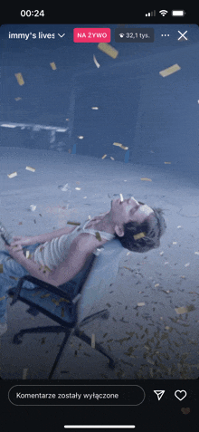 a man laying in a chair with confetti falling around him