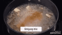 a close up of a pot of soup with a label that says ' siningang mix ' on it .