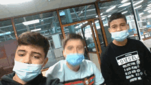 three boys wearing face masks and a diesel shirt