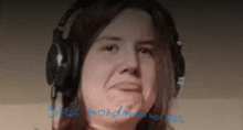 a woman wearing headphones with the words small mundane noises on the bottom right