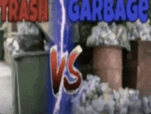 a sign that says trash garbage vs. in front of trash cans
