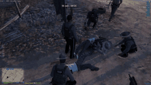 a screenshot of a video game shows a man laying on the ground and a police officer kneeling over him