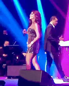 a woman in a striped dress is singing on stage