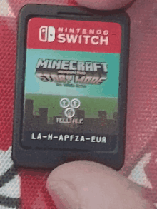 a person is holding a nintendo switch game card for minecraft story mode