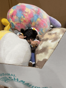 a child is laying on top of a box that says original marshmallows