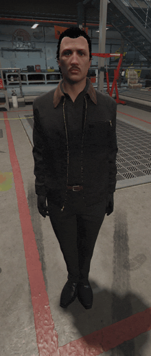 a man in a black jacket and black pants stands in a garage