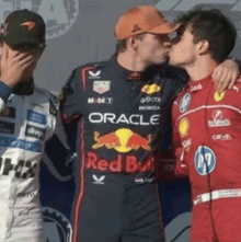 a man wearing a red bull shirt kisses another man