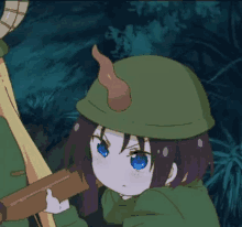 a little girl with blue eyes is wearing a green hat and holding a sword .