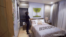 a woman is standing in a bedroom with the word bedroom on the bed