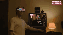 a man wearing 3d glasses stands in front of a tv screen that says wonky stonks on it