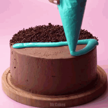 a chocolate cake with blue frosting and chocolate sprinkles