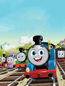 a group of thomas the tank engines are on the tracks