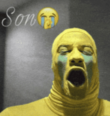 a man in a yellow mask is crying with the word son written above him
